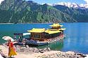 Uygur lady and tourist boat in 天池 Tianchi